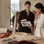 Human stylist and shopper reviewing a tablet moodboard in a modern boutique